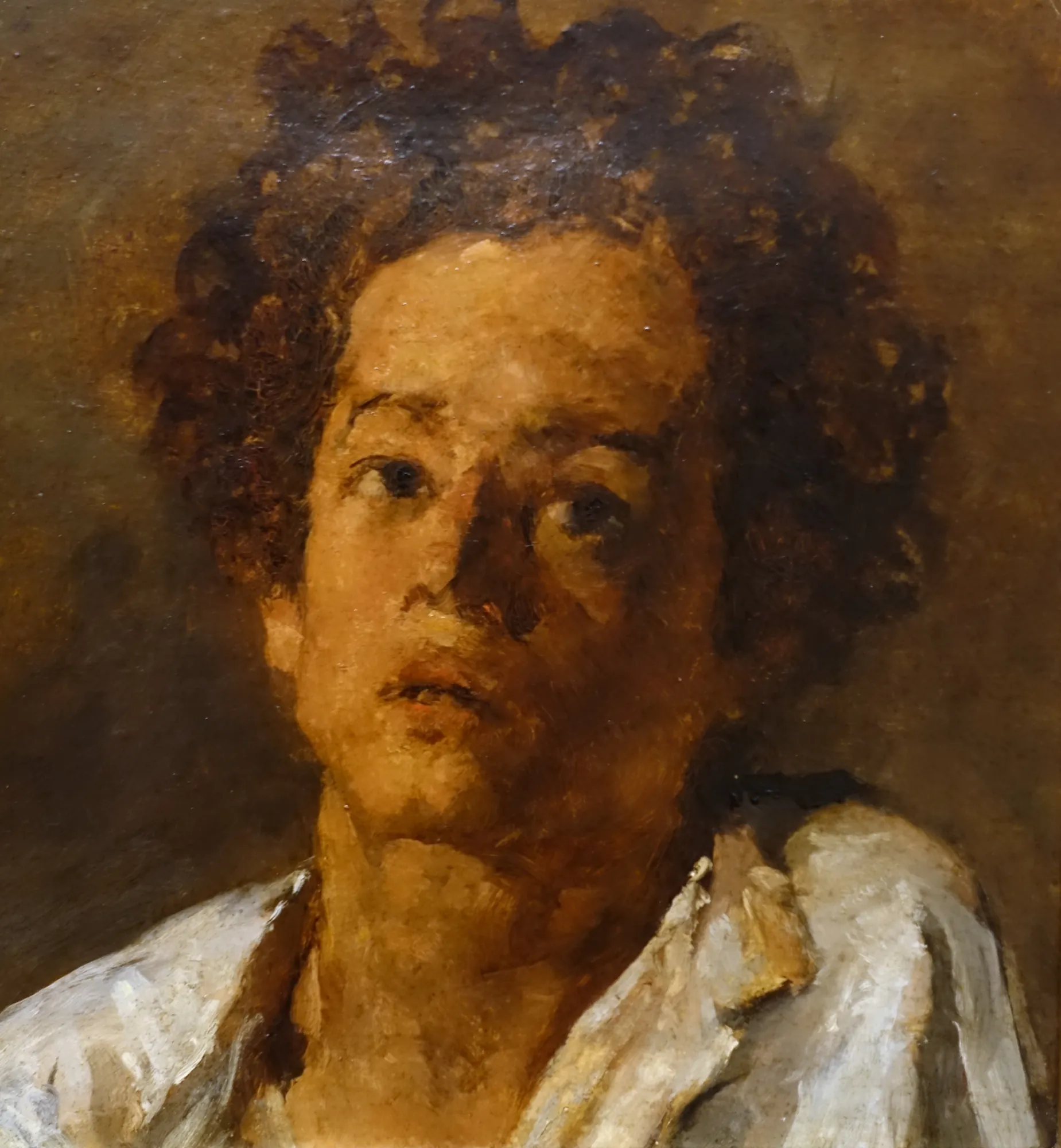 Head of a Boy Head of a Boy by Miguel Ângelo Lupi. A close-up oil study of a young boy with dark, curly hair looking upwards in a contemplative pose.