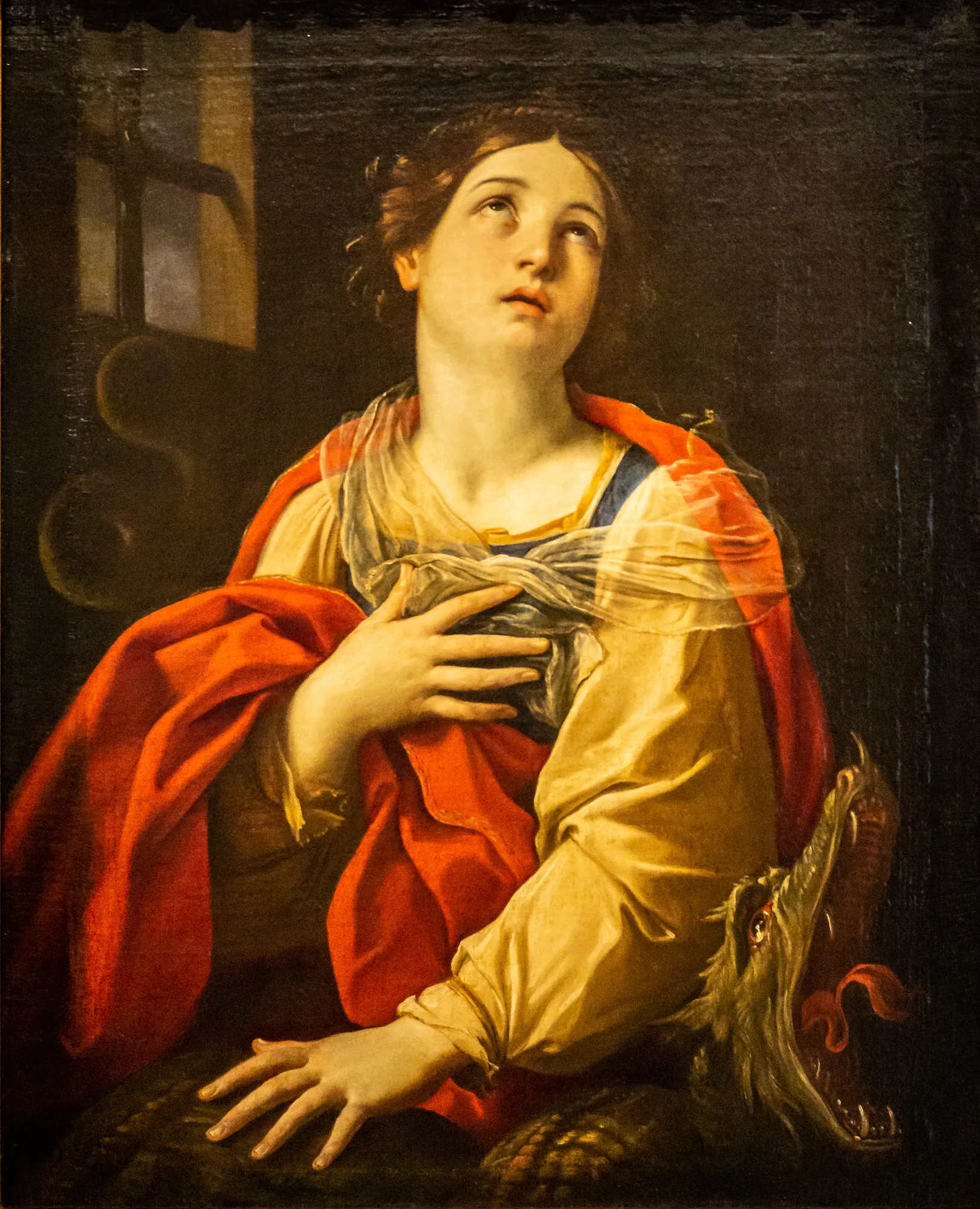 Saint Margaret Saint Margaret by Guido Reni. A woman in devotional prayer looks upward, draped in a vibrant red cloak, with a dragon's head visible in the lower right.