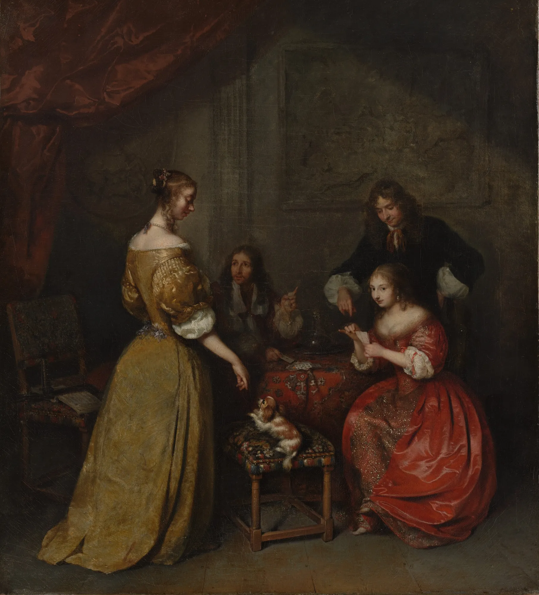 The Card Party The Card Party by Caspar Netscher. A group of elegantly dressed figures are gathered around a table playing cards in a dimly lit interior, accompanied by a small dog.